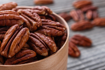 delicious pecan nuts on a rustic wooden background