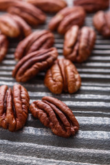 delicious pecan nuts on a rustic wooden background