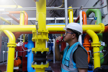 Worker with safety equipment on oil plant