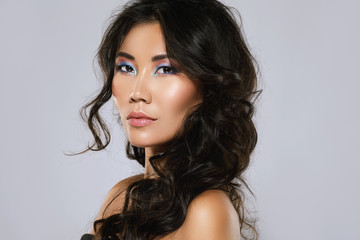 Young asian woman with a beautiful curly hair and make-up - obrazy, fototapety, plakaty