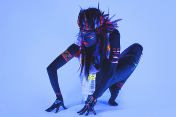 Woman with a neon makeup in ultraviolet light