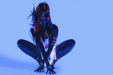 Woman with a neon makeup in ultraviolet light