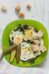 fried eggs with chard and marinated cornichons