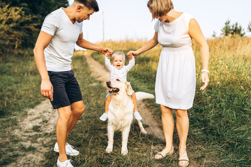 Young happy family with dog have fun outdoor