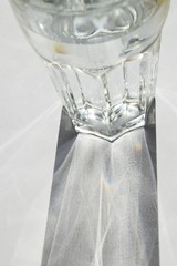 light shining through a glass of water with white background