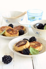 Cottage cheese pancake with honey and blackberries, vertical
