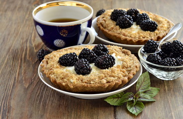 Tartlets with cream and blackberries, copy space