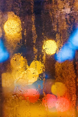 Rain drops on window with bokeh. Vertical composition