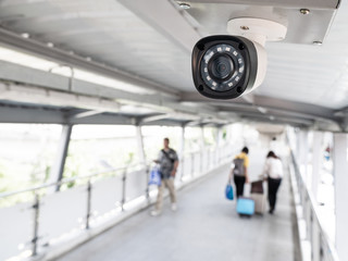 CCTV or surveillance computer operating at the bridge, walkway, street Blurred with people walking.