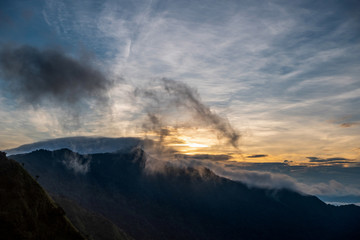 View of nature. The top of the mountain, the sun, the mist and the mountain. at Doi Phu Kha, Nan. Low light and noise.