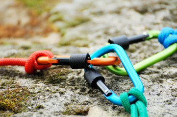 Carabiner  on rocky background.
