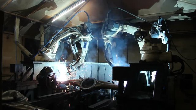 Welding robots movement in a car factory, automotive parts industry