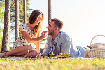 Couple in love enjoying picnic time and food outdoors