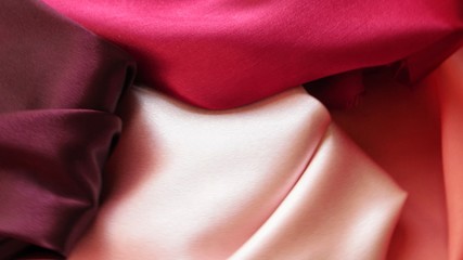 Pink, coral and crimson satin, drapery, textile background