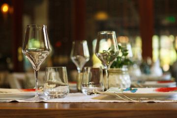 Table setting in the restaurant. glass in the foreground.
