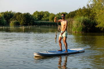 Man stand up paddleboarding