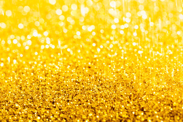 Gold glitter close-up background with shallow depth of field