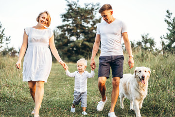 Young happy family with dog have fun outdoor
