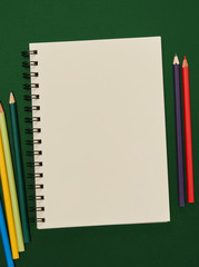 Notebook and multi-colored pencils