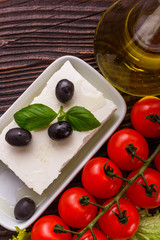 A piece of feta cheese on a wooden rustic background