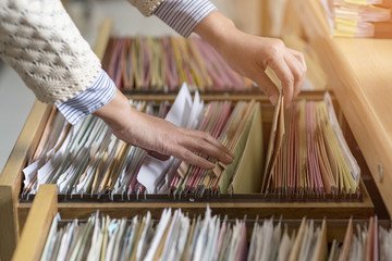 Colorful business documents are placed in a filing cabinet in the office.