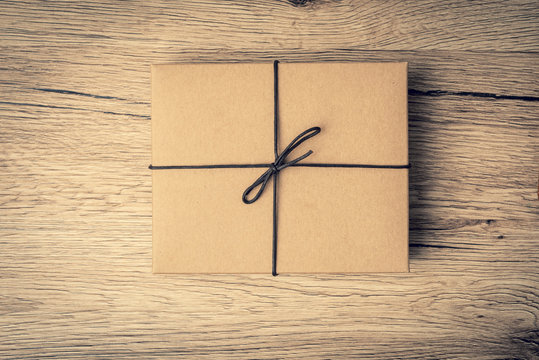 Brown gift box pace on wood background