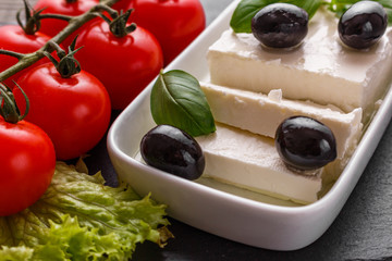 A piece of feta cheese on a wooden rustic background