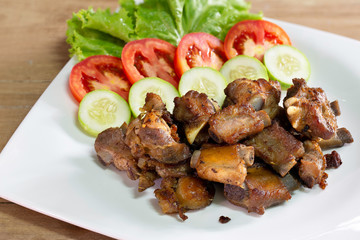 Fried deep pork ribs in white dish with vegetable thai food