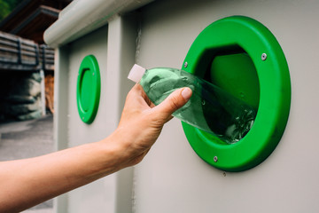 Selective garbage in Switzerland - sorting glass bottles of different colors