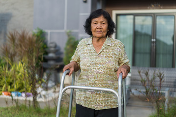 senior woman walking with walker
