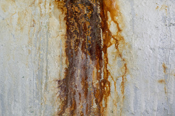 Old, rusty concrete wall with rust and cracks