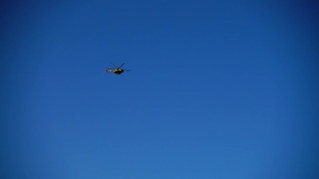 The helicopter in the sky. Slow motion.