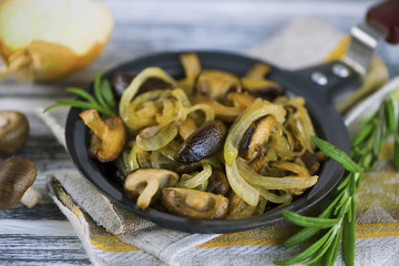 fried Japanese mushrooms shiitake with onions and spices in a frying pan