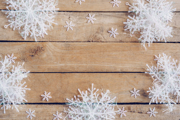 Wooden brown christmas background with snowflakes and christmas decoration.