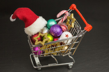 mini shopping cart with christmas baubles