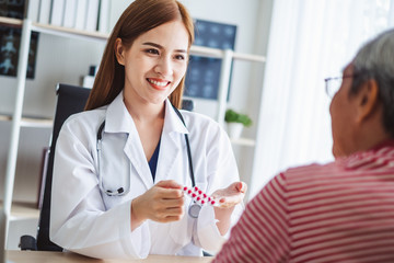 Asian doctor woman explaining old patient for taking medicine, asian medical concept