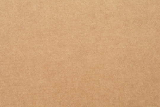 Texture of plain brown cardboard, close up