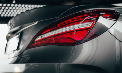 Closeup modern luxury grayBack lights headlight and head lamp of powerful beast sport car ....