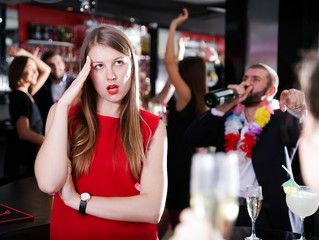Offended woman with drunk man on party at nightclub