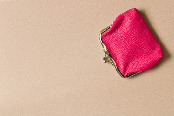 Pink wallet on light background . Close up. Top view