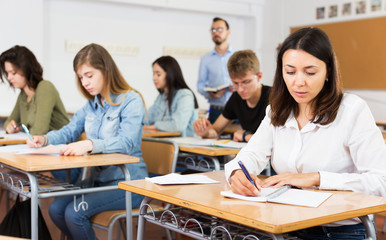 Fototapeta premium Girl writing test in classroom