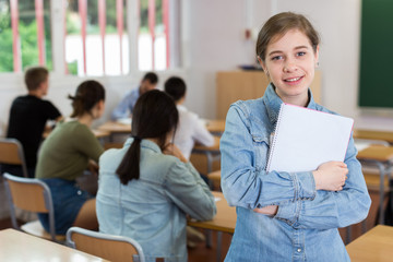 Portrait of smiling schoolgirl who is satisfied of lessons