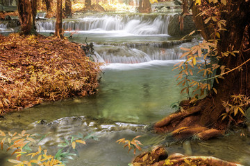 limestone waterfall at autumn forest