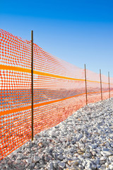 Construction site with safety orange and white gravel