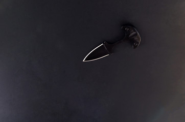 A black small knife. The knife is like a spear.