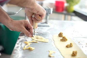 Chef  prepared homemade raw tortellini pasta. Italian pasta,gluten-free