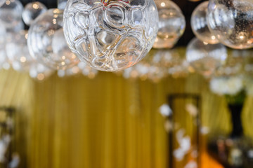 Fototapeta na wymiar Blurred bokeh luxury light background in restaurant interior