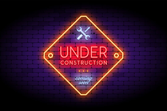 Under Construction sign in trendy neon style on the brick wall.