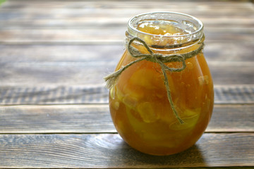 Apple jam in a jar on a wooden background