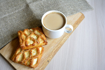 a cup of coffee with milk and baked 